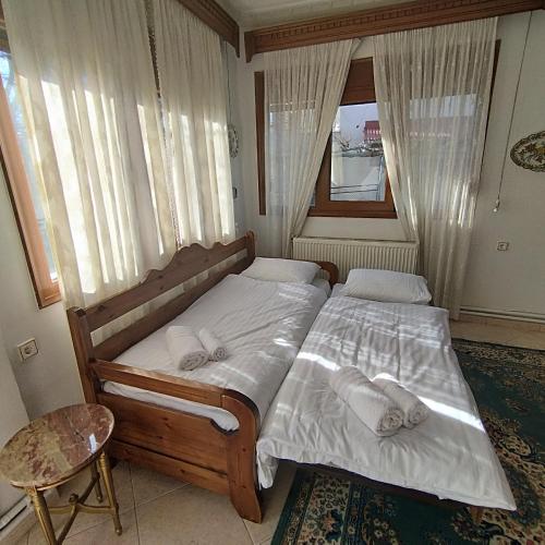 a bedroom with two beds and a window at Grevena country House in Kalirákhi