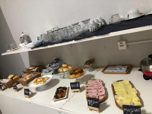 a counter topped with lots of different types of food at Ágape Hotel in Rio Verde