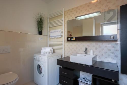 a bathroom with a washing machine and a sink at Apartments Kaya in Pula
