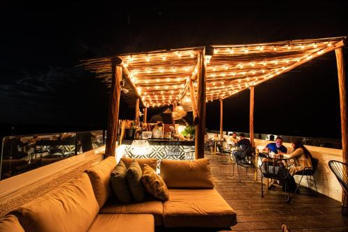a couch sitting on a deck at night at Hotel Casa HX - Adults Only in Holbox Island