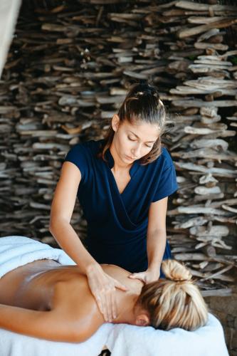 a woman getting a massage from a mans back at Sofitel Golfe d'Ajaccio Thalassa Sea & Spa in Ajaccio