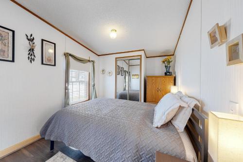 a bedroom with a bed and a dresser and a window at Assateague Point Vacation in Berlin