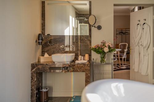 a bathroom with a sink and a large mirror at LA VILLA in Terraube