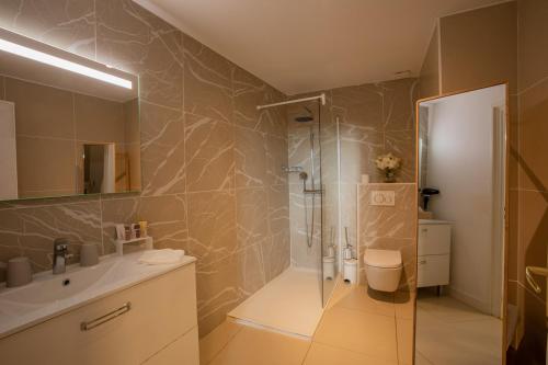 a bathroom with a shower and a sink at LA VILLA in Terraube