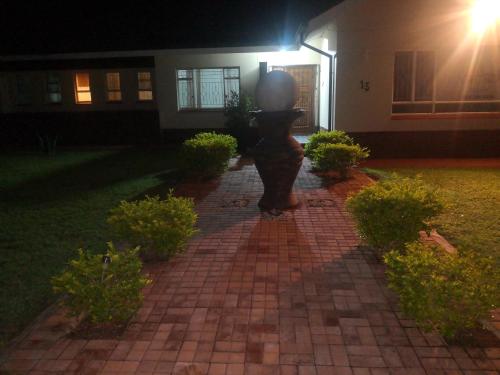 a statue in front of a house at night at 15 On Reitz Bela bela in Bela-Bela