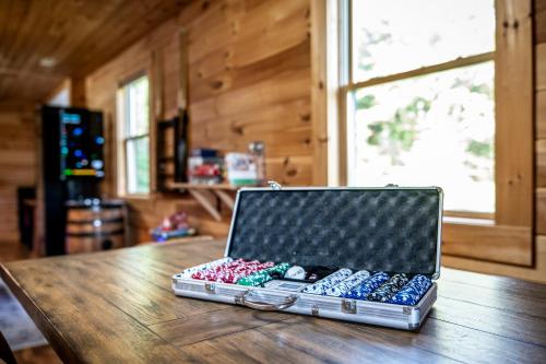 a laptop computer sitting on top of a wooden table at Peace in the Valley - Mtn VIEWS w/HotTub, GameRoom, Theatre, Arcade in Sevierville