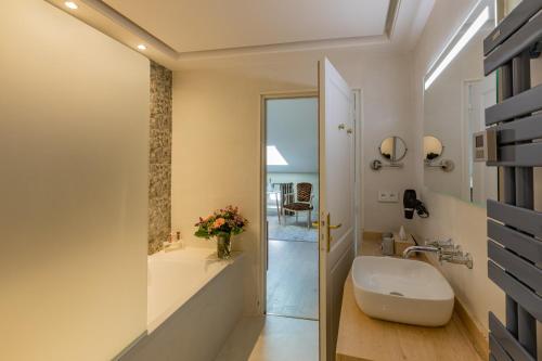 a bathroom with a sink and a mirror at LA VILLA in Terraube