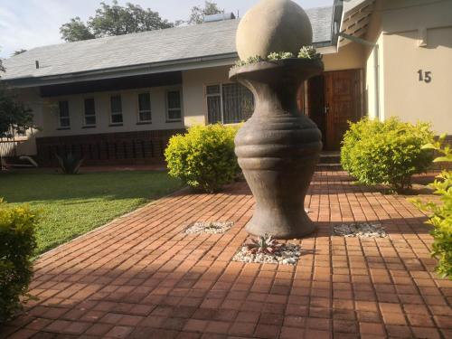 a statue in front of a house at 15 On Reitz Bela bela in Bela-Bela