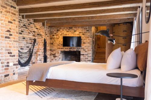 a bedroom with a bed and a brick wall at The Edelweiss Estate in Gatlinburg
