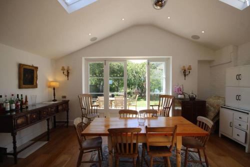 a dining room with a wooden table and chairs at Downsview in Kingsdown