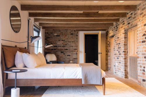 a bedroom with a brick wall and a bed at The Edelweiss Estate in Gatlinburg