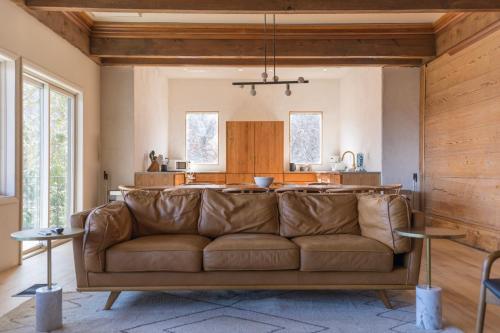 a living room with a couch and a kitchen at The Edelweiss Estate - Mountain Views in Gatlinburg