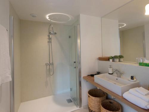 a bathroom with a shower and a sink at Confort moderne à Sauzon avec vue sur port, accessible PMR, wifi, linge inclus - FR-1-418-184 in Sauzon