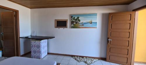 a room with a door and a painting on the wall at Pousada Club de Poças in Conde