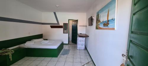 a small room with a bed and a bathroom at Pousada Club de Poças in Conde