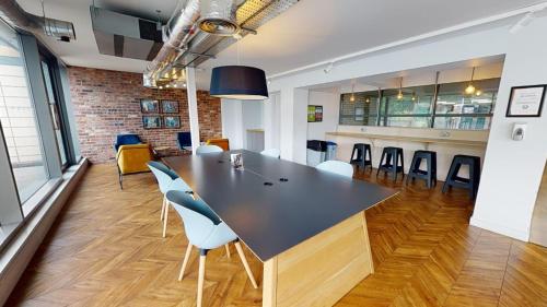 a dining room with a large table and chairs at Wilmslow Park Manchester in Manchester