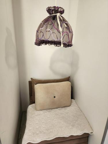 a lamp hanging over a bed with a pillow at Apartments Ohrid Lake in Ohrid