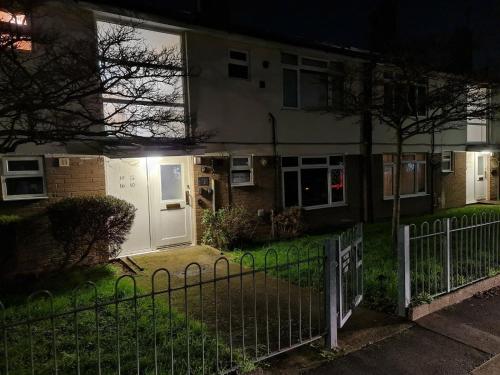 a house with a gate in front of it at night at A one spacious bedroom apartment in Welling