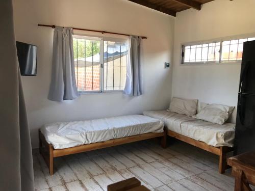 a room with two beds and a window at India del mar II in Chapadmalal