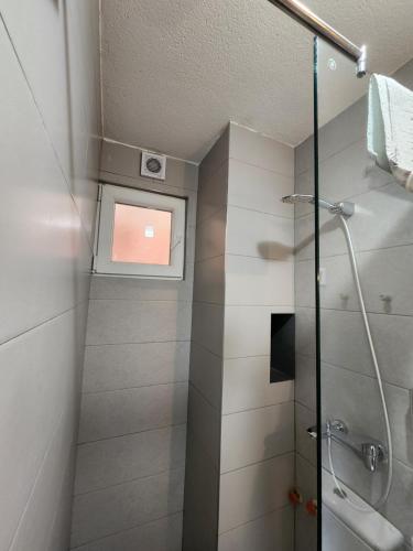 a bathroom with a shower with a glass door at Apartments Ohrid Lake in Ohrid