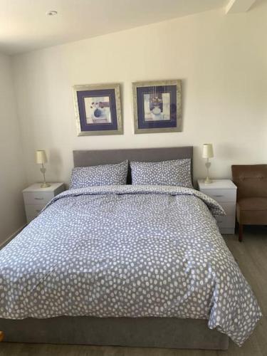 a bedroom with a large bed with two night stands at Sunny Nook, Pretty 1 bed modern cottage close to Woolacombe in Ilfracombe