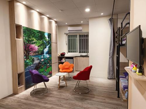 a waiting room with colorful chairs and a tv at 博愛泊旅讀心境 in Hualien City