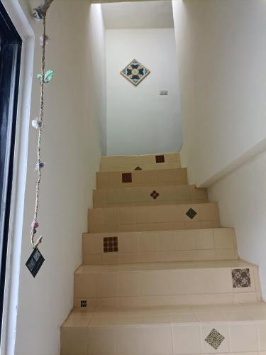a set of stairs with kites on the wall at 博愛泊旅讀心境 in Hualien City
