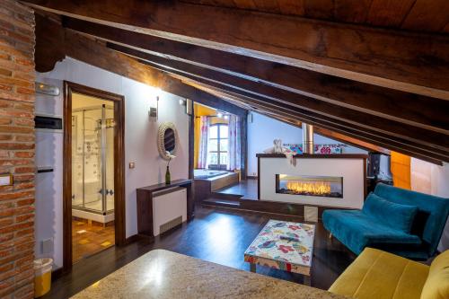 a living room with a fireplace and a brick wall at Posada la Leyenda in Santillana del Mar