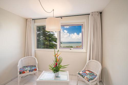 a room with two chairs and a table and a window at Karibea Squash Hôtel in Fort-de-France