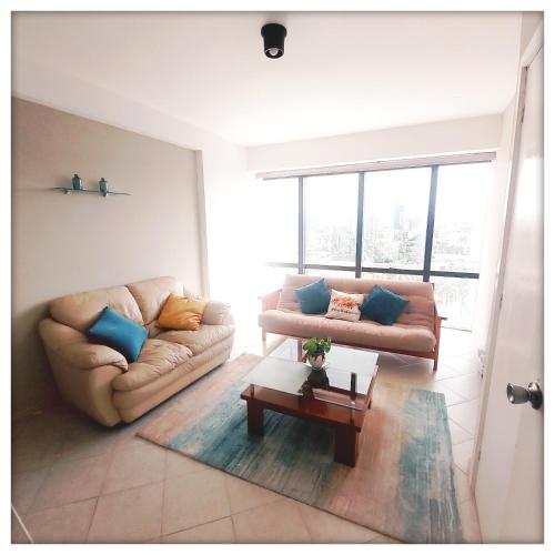 a living room with two couches and a coffee table at Executive suite in gastronomic district in Valencia