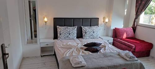 a dog laying on a bed in a bedroom at Apartments Ohrid Lake in Ohrid