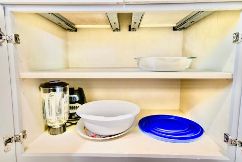 a cupboard with dishes and a blender and plates at Modern Boho Retreat in Corvallis
