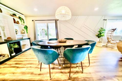 une salle à manger avec une table ronde et des chaises bleues dans l'établissement Modern Boho Retreat, à Corvallis