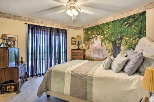 una camera da letto con un letto e un dipinto sul muro di Cozy North Carolina Abode - Deck, Grill and Fire Pit a Burnsville