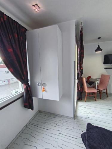 a white cabinet in a room with a window at Apartments Ohrid Lake in Ohrid