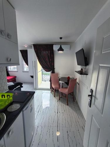 a kitchen and dining room with a table and chairs at Apartments Ohrid Lake in Ohrid
