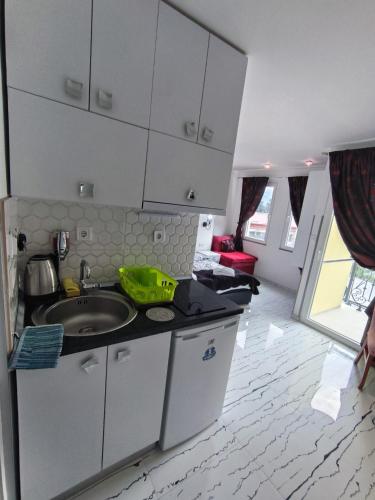 a kitchen with a sink and a counter top at Apartments Ohrid Lake in Ohrid