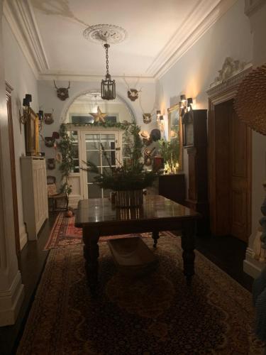 a dining room with a table in the middle of a room at Ballyteige Lodge in Ballyteige Bridge