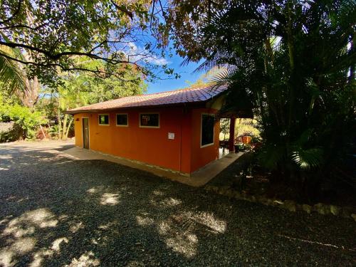 a small house with a red roof on a street at TERMINAL VERDE PRIVATE APARTMENTS NEAR AIRPORT 24h SELF CHECK IN in Concepción