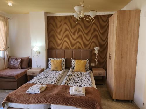 a bedroom with a large bed and a couch at Apartments Ohrid Lake in Ohrid