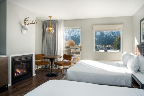 a hotel room with a bed and a fireplace at Hotel Ketchum in Ketchum