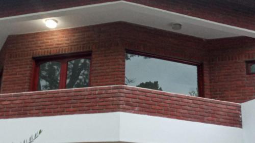a brick building with a window on top of it at Santa Teresita Sobre El Monte in Santa Teresita