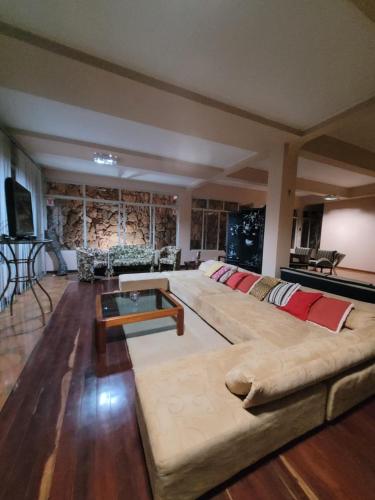 a large living room with a couch and a table at Kzazendf Cama&Cafe Hospedagem Familiar in Brasilia