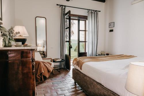 a hotel room with a bed and a mirror at Susafa in Vallelunga Pratameno