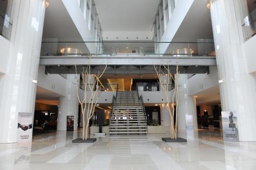 a lobby with a staircase in a building at EPIC SANA Luanda Hotel in Luanda