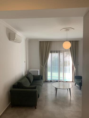 a living room with a couch and a table at Orya Aparts in Gümbet