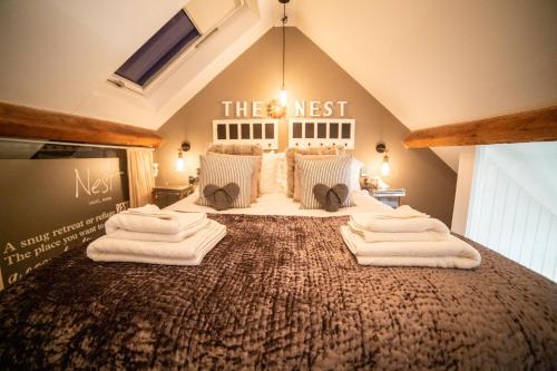 a bedroom with a bed with towels on it at The Nest Barnlette in Wrenbury