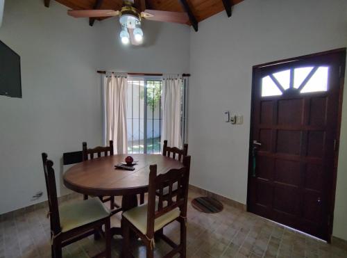 a dining room with a table and chairs and a door at Alojamientos Estrellas Azules in Colón