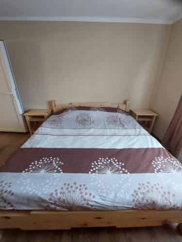 a bedroom with a bed with a blanket on it at Seoska kuća Rakić - Tara in Rastište