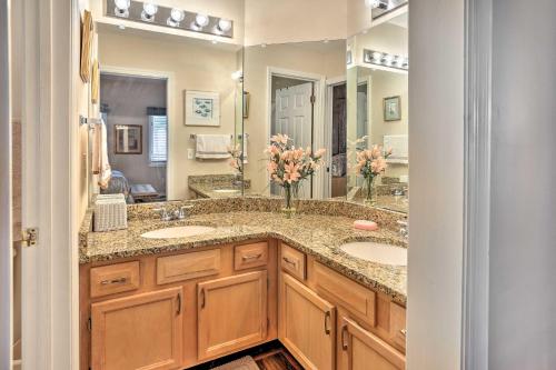 a bathroom with two sinks and a large mirror at Myrtle Beach Condo in Tidewater with Pool and Golf! in North Myrtle Beach
